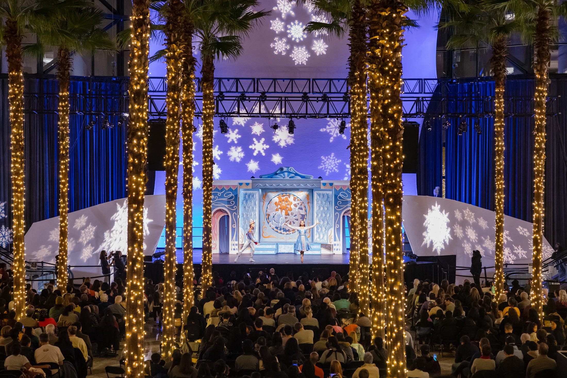 Holiday lights installation or festive yellow window display at a public space.