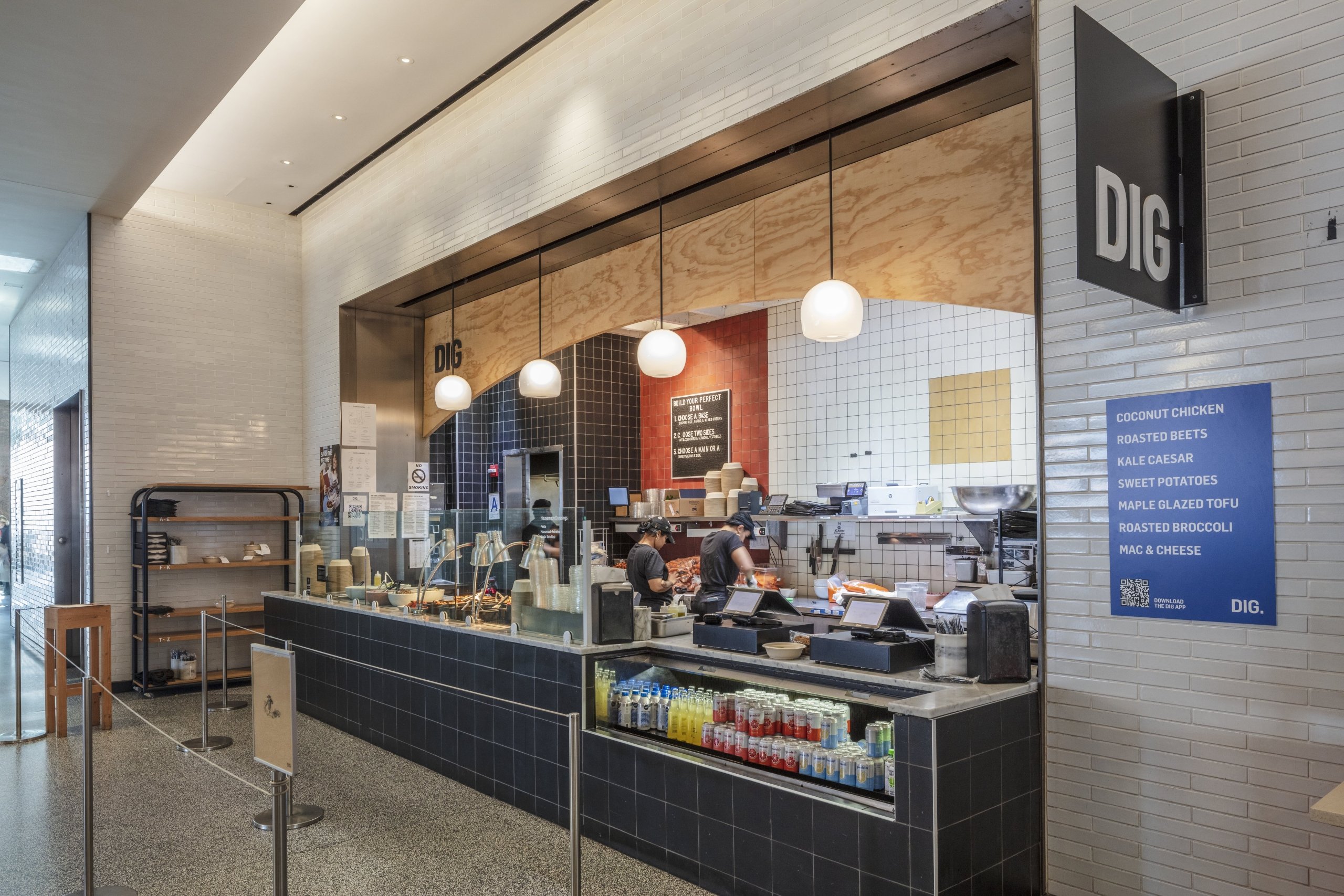 Service counter of DIG with food items displayed under glass.