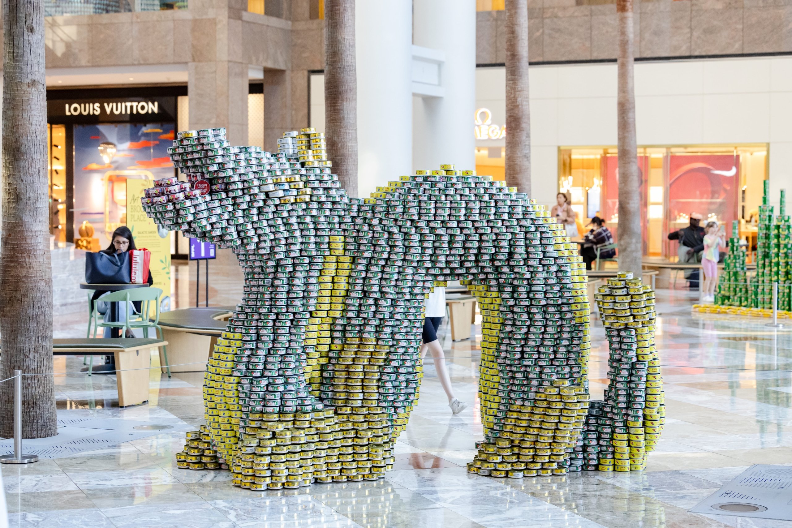 Canstruction dragon sculpture made of cans
