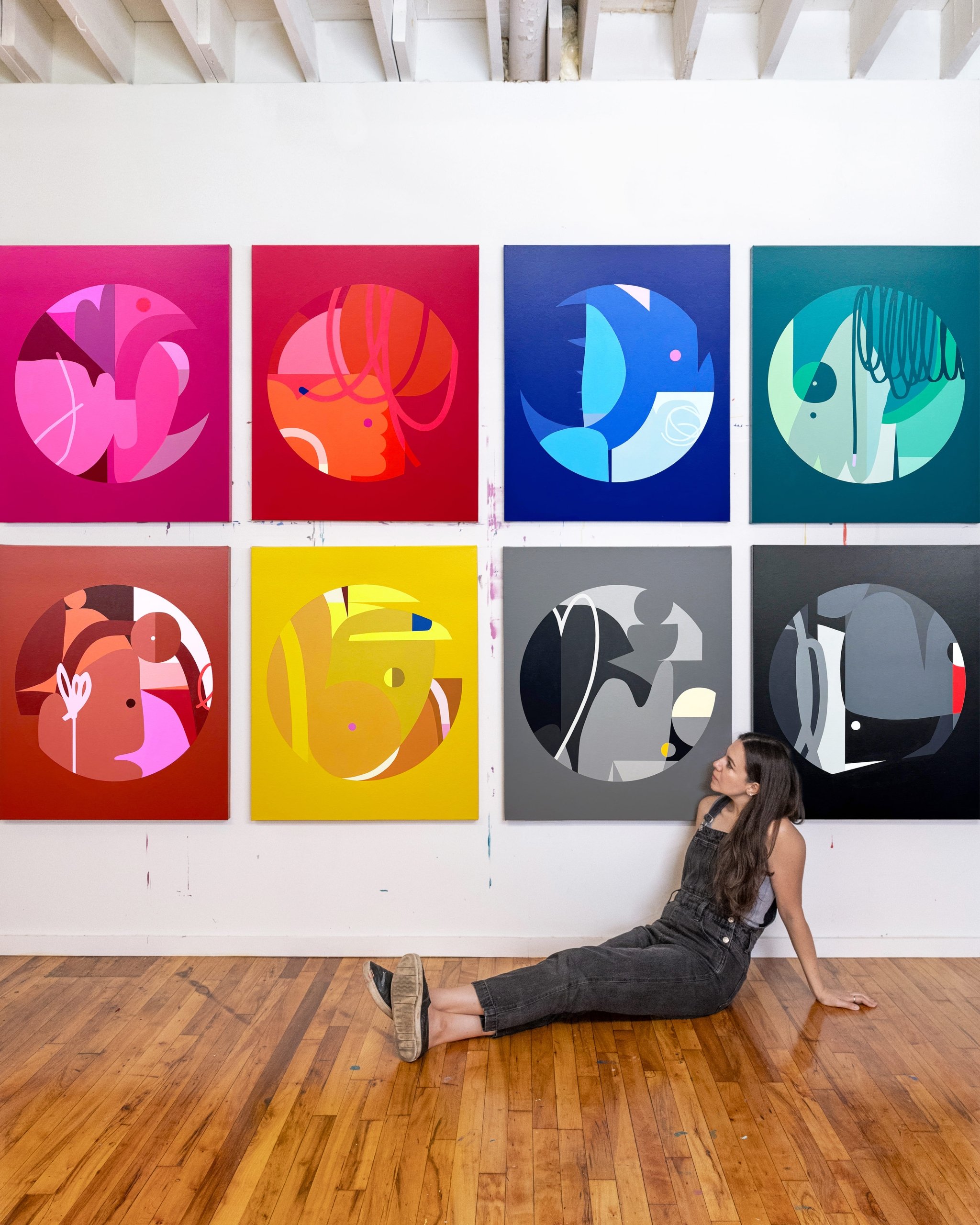 Art display featuring a series of colorful, abstract prints in various colors and shapes.