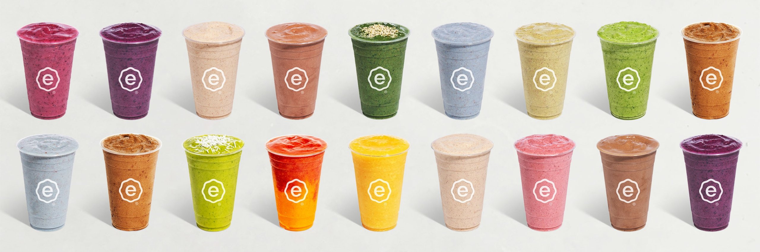 Collection of colorfu smoothies in shades of green, yellow, pink, and orange.