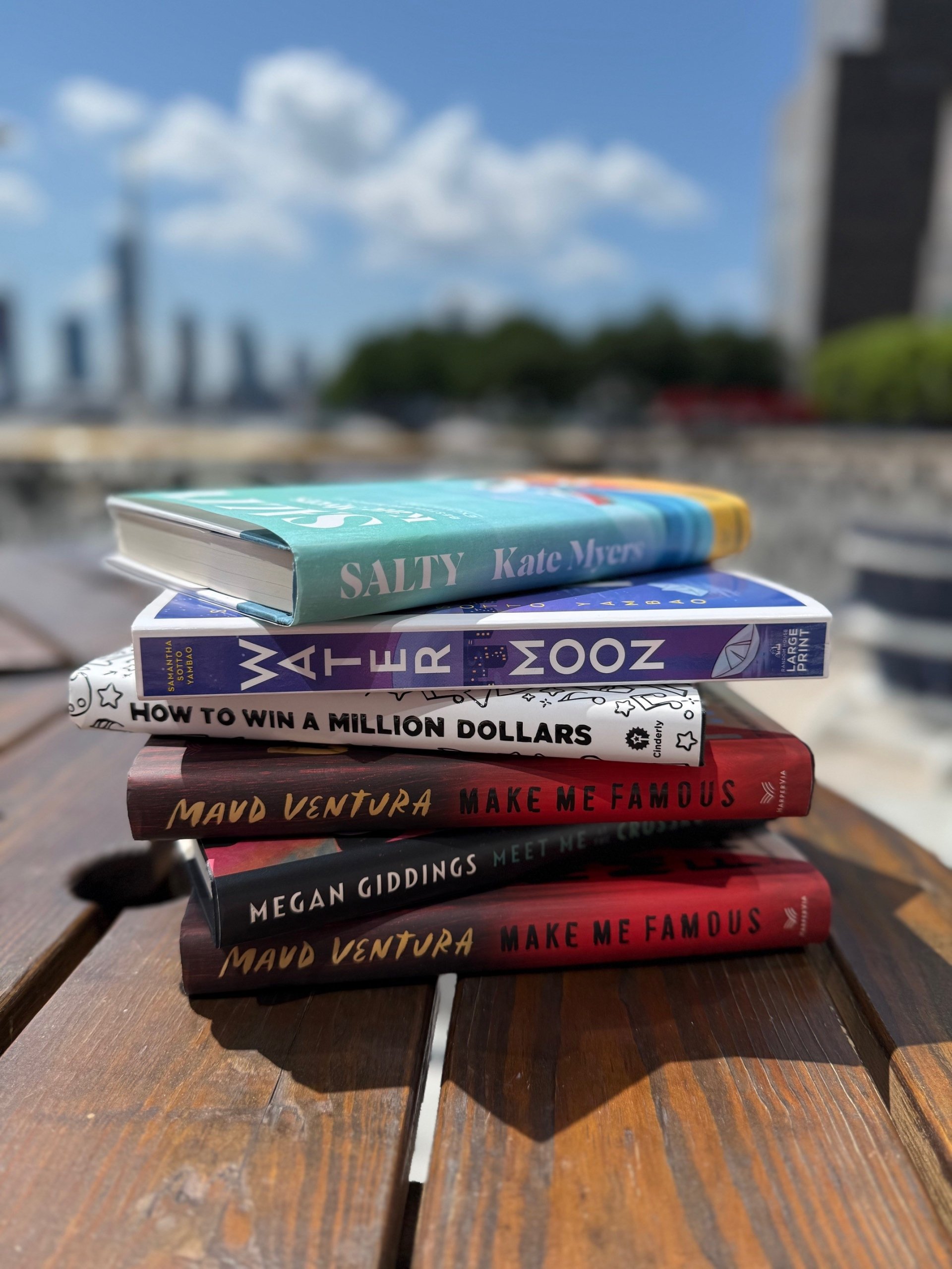 Stack of books on a park bench