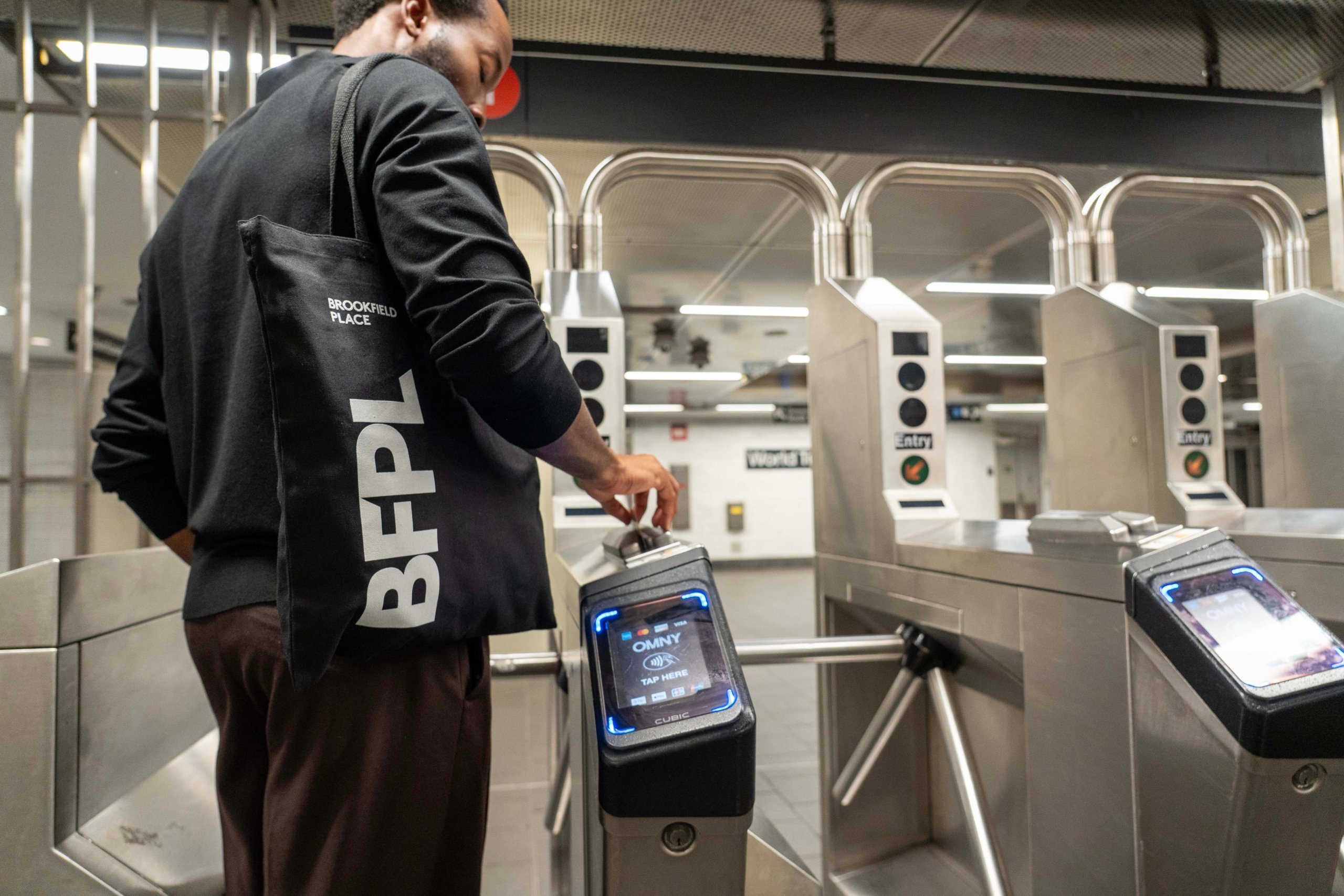 Man scanning subway ticket in NYC