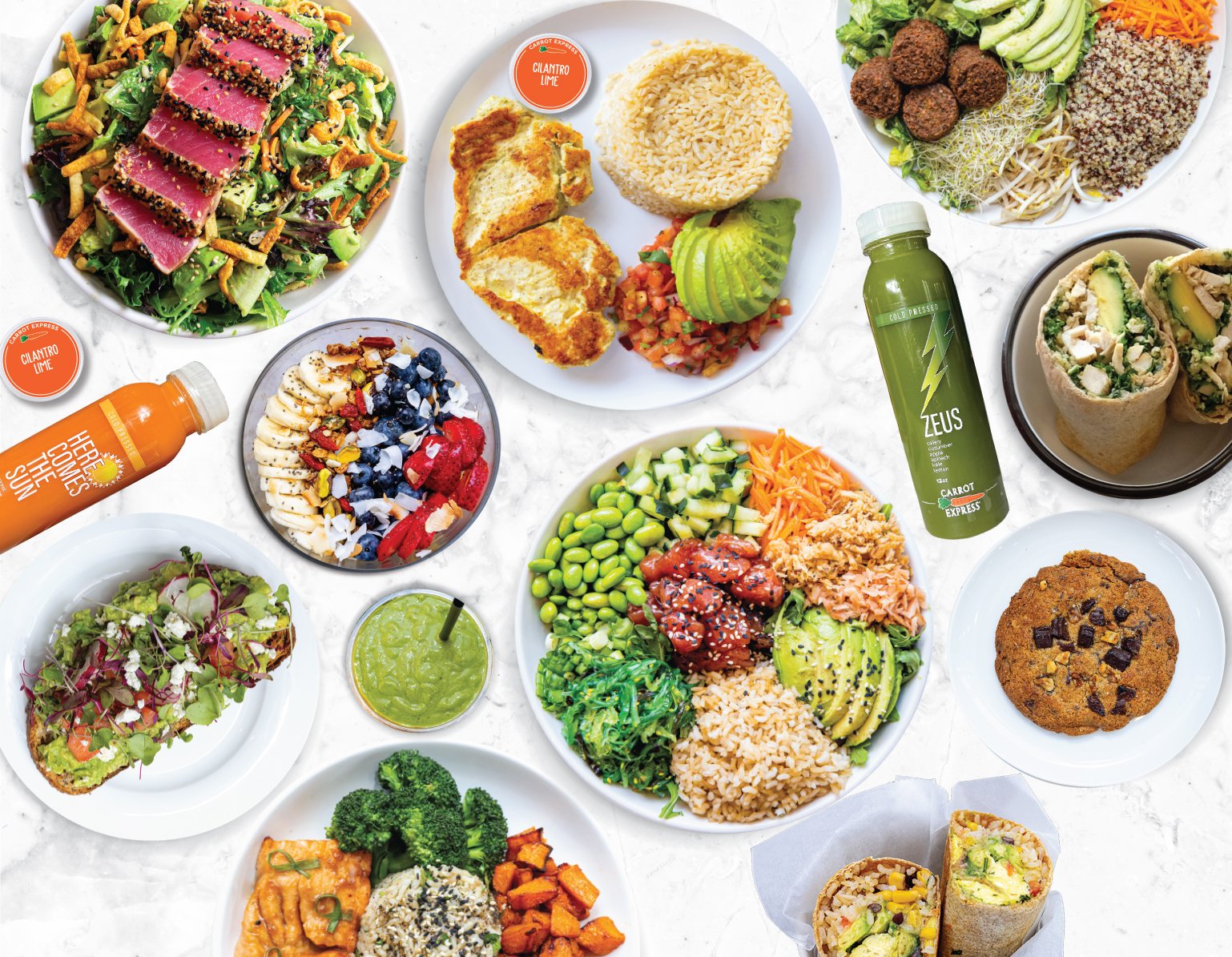 A top-down view of a table full of healthy meal options from Carrot Express, including a seared tuna salad, various grain and vegetable bowls, avocado toast, juices, and a chocolate chip cookie.