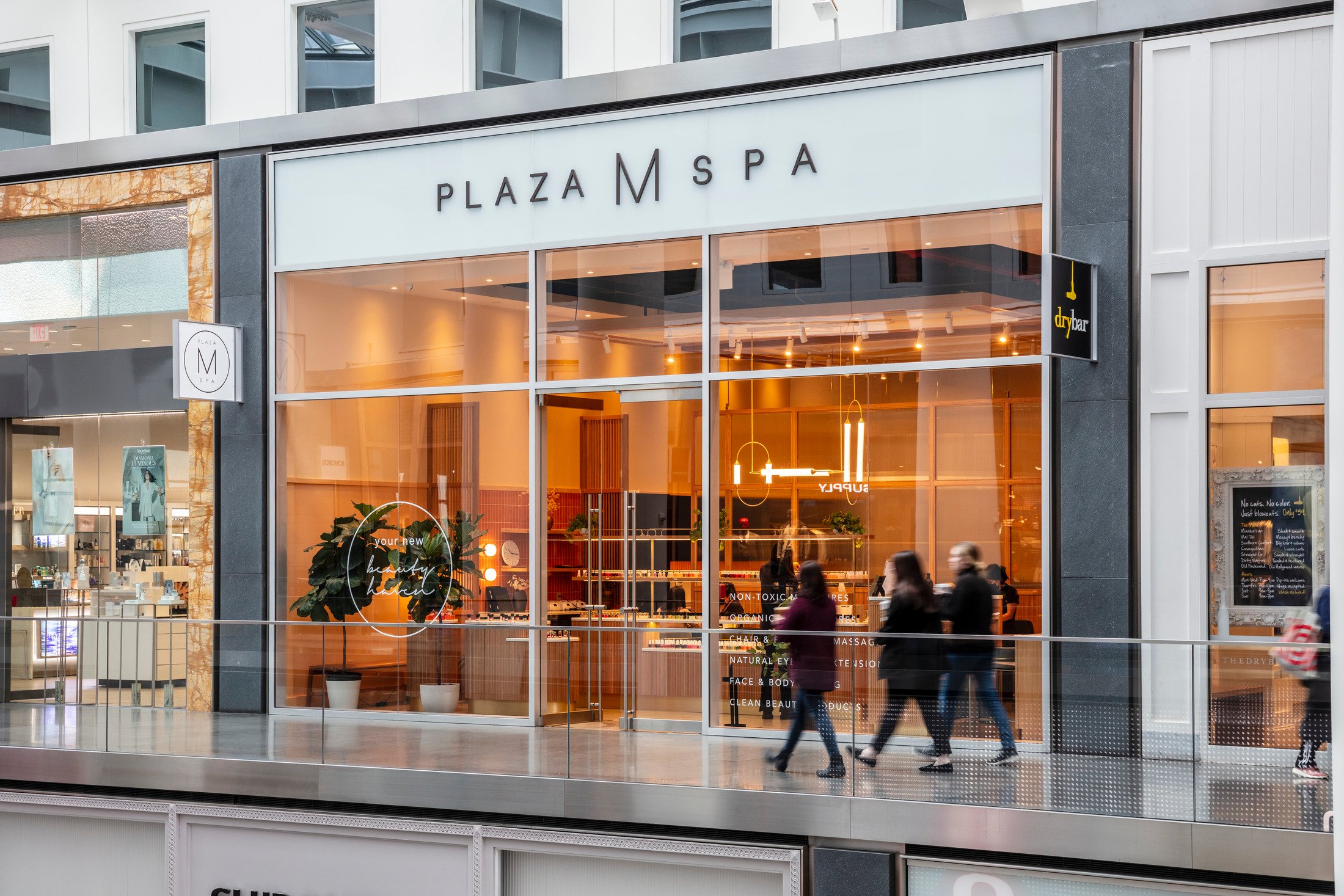 Storefront with large windows displaying merchandise and the text