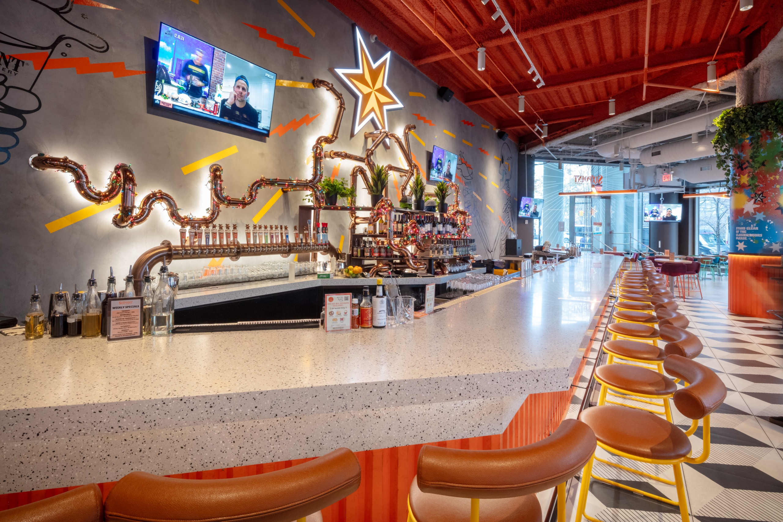 Bar area of a restaurant with bright overhead lighting.